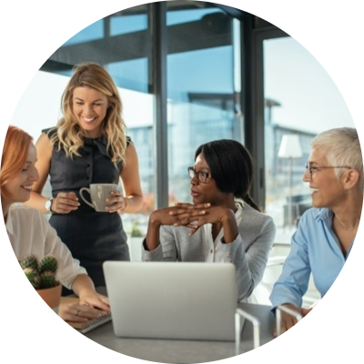 Women around a computer in a business meeting